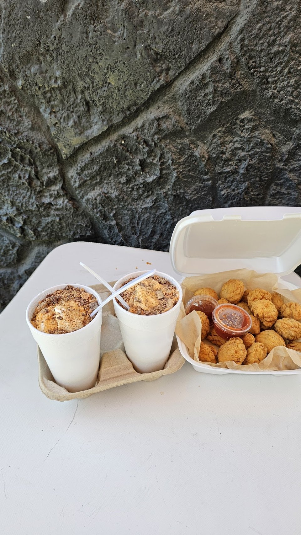 Menu board with burgers and sides.